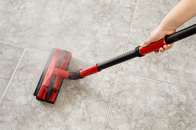cleaning tile with a steamer