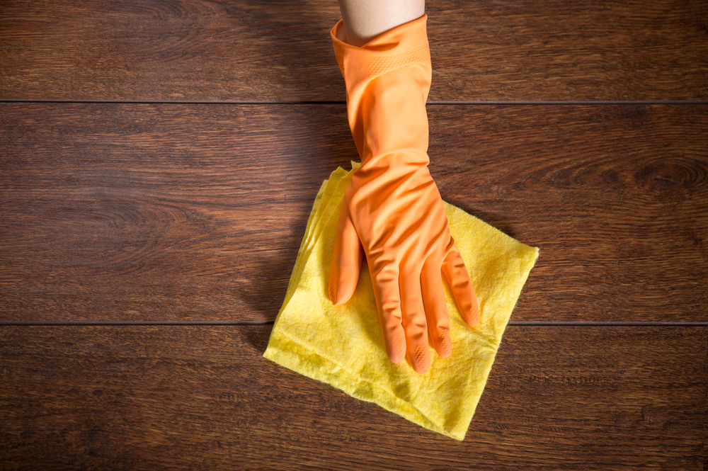 Close,up,of,hand,cleaning,the,wooden,parquet