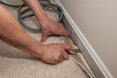 man lifting carpet